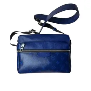 Pre-owned Louis Vuitton Tiga Leather Crossbody Bags Outdoor Messenger Monogram Pacific Taiga Blue Crossbody Bag with Embossed Monogram Detailing & Adjustable Canvas Strap