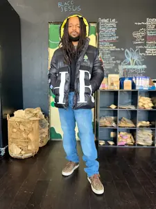 Guanabana Trap Puffer Coat - Black Fabric Jacket with "HE" Design, Comfortable Fit for Women