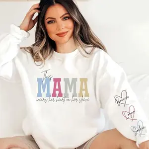 Personalized This Mama Wears Her Heart On Her Sleeve Sweatshirt With Kids Names, Custom Mama Crewneck, Mother's Day Gift, Mom Life Shirt