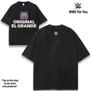 El Grande Americano Legacy Built on Power Precision and Unstoppable Momentum A Career Defined by High Impact Matches Fierce Rivalries and Championship Pursuit Dominating the Ring with Style 230gsm Premium Cotton Tee Shop Now graphic