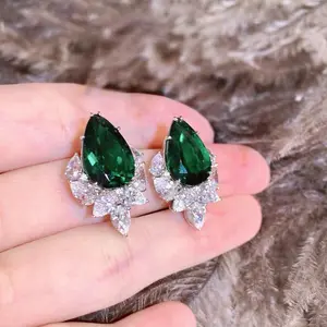 A pair of luxurious hand polished Mosonite green earrings paired with green zircon. Exquisite craftsmanship. Sparkling Mosonite and green zircon. Master level aesthetic design. Excellent quality. Brilliant and radiant. High quality manual polishing