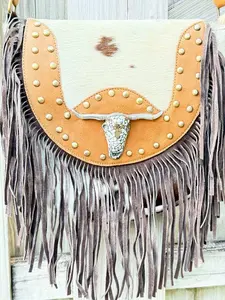 The Sundown Rider Cowhide and Leather Fringe Crossbody with Bullhead Mosiac Concho Genuine Hair-on Cowhide Body Adjustable Strap Studded Leather Trim Zipper and Flap Closure