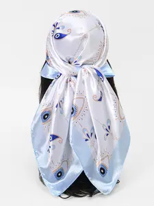 Wrap yourself in elegance and protection with this 90 cm silk scarf, featuring a sophisticated evil eye print in soft blue and gold tones. Luxuriously smooth and lightweight, it's perfect for styling as a headscarf, neck accessory, top, or statement piece