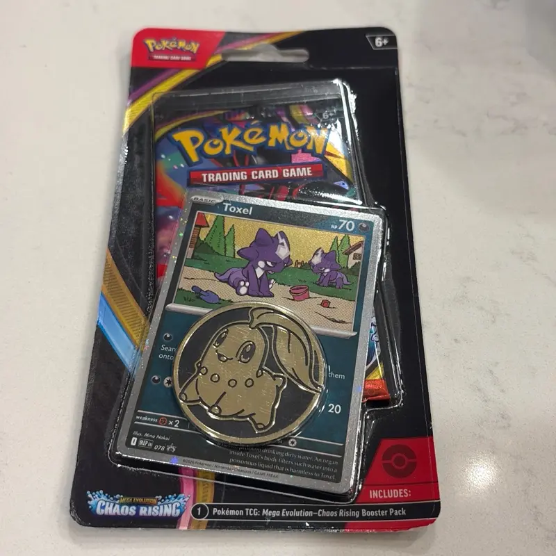 This is a Pokemon TCG: Chaos Rising Checklane Blister pack featuring a Toxel promo card and a collector's coin.