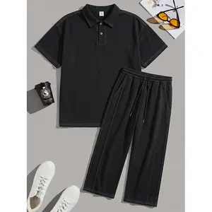 Men’s basic black polo set with visible stitching, minimalist design, loose and comfortable short-sleeve top and capri pants—everyday two-piece set