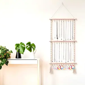 Hanging jewelry storage bag, equipped with a braided necklace rack and hook, used for wall-mounted jewelry storage.