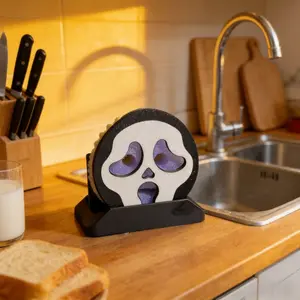 A Single Piece of a 3D-Printed Humorous Face Sponge Holder in a Black And White Design, Featuring a Skull Shape for Storing Water on Your Bathroom Counter. This Is an Excellent Accessory for Bathroom Organization. It Is an Officially Licensed Produc