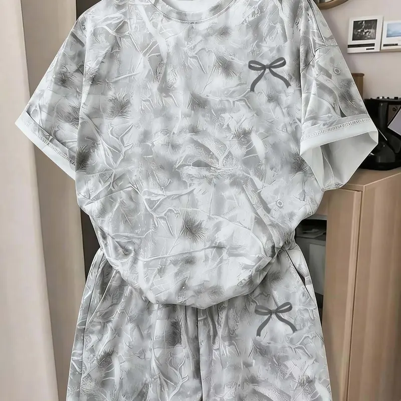 Trendy 2-Piece Camo Print Lounge Set Loungewear Matching Pj Set | Short Sleeve Tee & High-Waist Shorts | Adorable Black Bow Accent | Soft Fabric, Perfect for Sleep, Lounging or Casual Outings | Women's Fashion Pajamas Nightwear