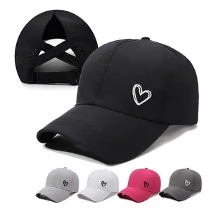 A Solid-color Heart-shaped Baseball Cap with an Adjustable Snapback Strap, Designed to Be Worn with a High Ponytail Tied Across the Back. Features a Breathable Mesh Panel at the Back.