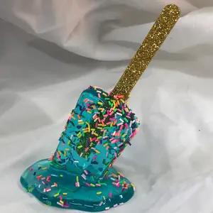 Pop art sculpture statue melting popsicle ice blue color with rainbow sprinkles