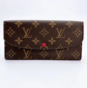 Pre-owned Louis Vuitton canvas Small Leather Goods Emilie Monogram Wallet with Red Interior Slim Design, Snap Button Closure, Multiple Card Slots, Zippered Coin Pocket