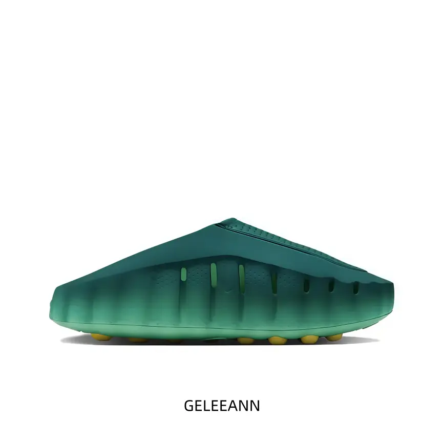 This slip‑on sport slide features unique green gradient outer shell with vent cut‑outs and warm yellow traction studs, delivering lightweight comfort for beach trips and casual daily indoor‑outdoor wear.