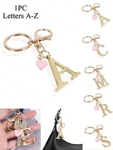 A high-end elegant gold letter keychain, 3D letter charms A-Z, with a pink heart charm, fashionable alloy key ring, backpack decoration, car keychain, couple gift, classic minimalist keychain, decorative, bag accessory, Keychain For Bags
