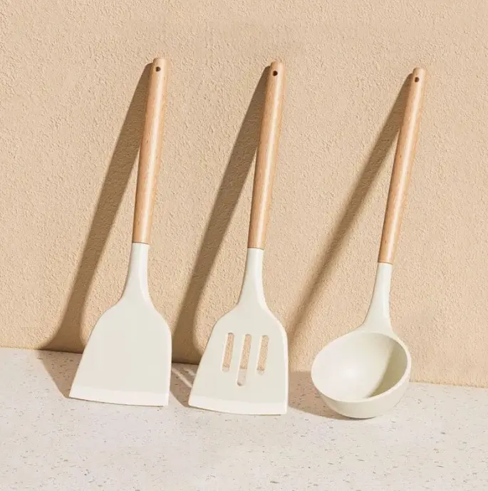 Complete 3-piece cookware tool kit with matte off-white silicone heads and lightweight wooden handles, heat resistant and scratch-free for everyday family meal prep tasks