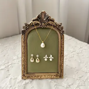 A Small Display Stand for Jewelry Featuring a -Patterned Frame And a Green Velvet Surface, Designed for Showcasing Resin Accessories, Suitable As a Gift for Women.