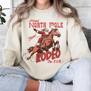 North Pole Rodeo Western Crewneck Sweatshirt Or Hoodie, Print T-shirt, 90s Cowgirl Graphic Tee, Vintage Mama Clothing Gift, Trendy Unisex Clothes, Retro Women's Coutry Music Concert, Trendy Western Holiday, Cute Country Christmas, Cowboy Santa