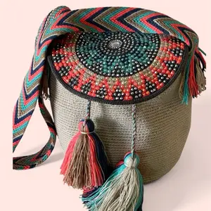 Handwoven wayuu medium size bucket bag. Handmade with two threads in crochet technique. Beaded design on round lid. War crossbody o shoulder strap.