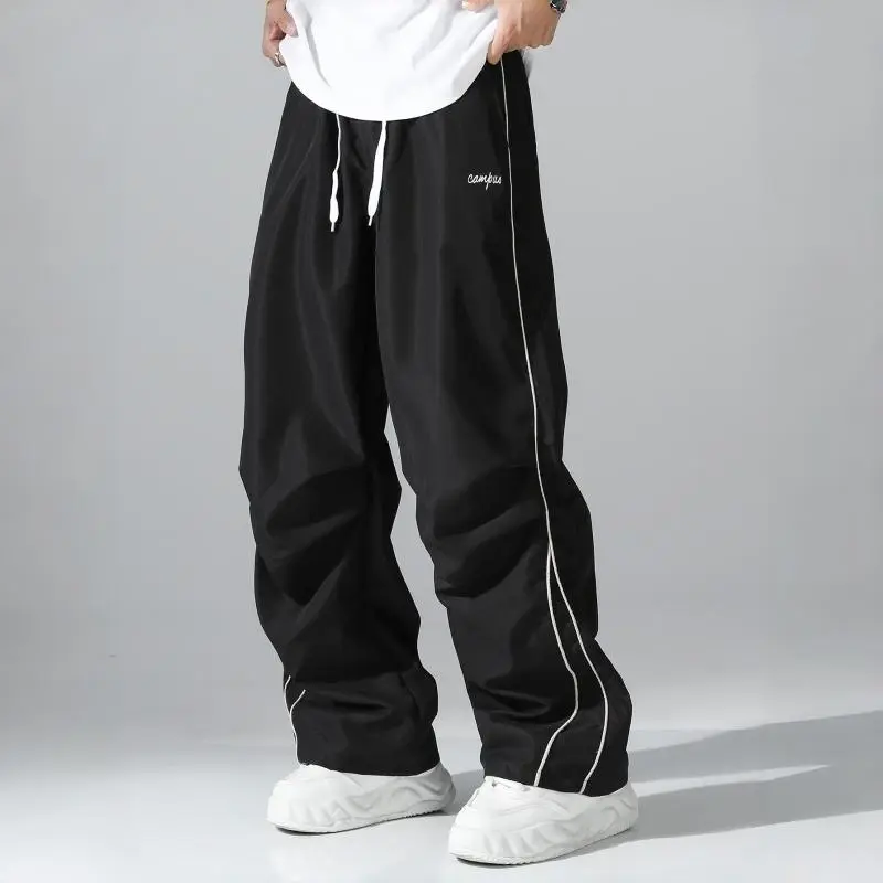 Men’s side-striped wide-leg casual pants with a drawstring waist, featuring a comfortable, breathable design suitable for all seasons—an everyday wardrobe essential.
