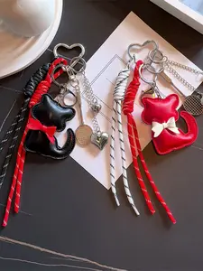 Retro light luxury texture heart-shaped contrasting tassel knot pendant, three-dimensional cat shaped design, decorated with badminton racket and bow elements, can be used as a bag hanger and keychain