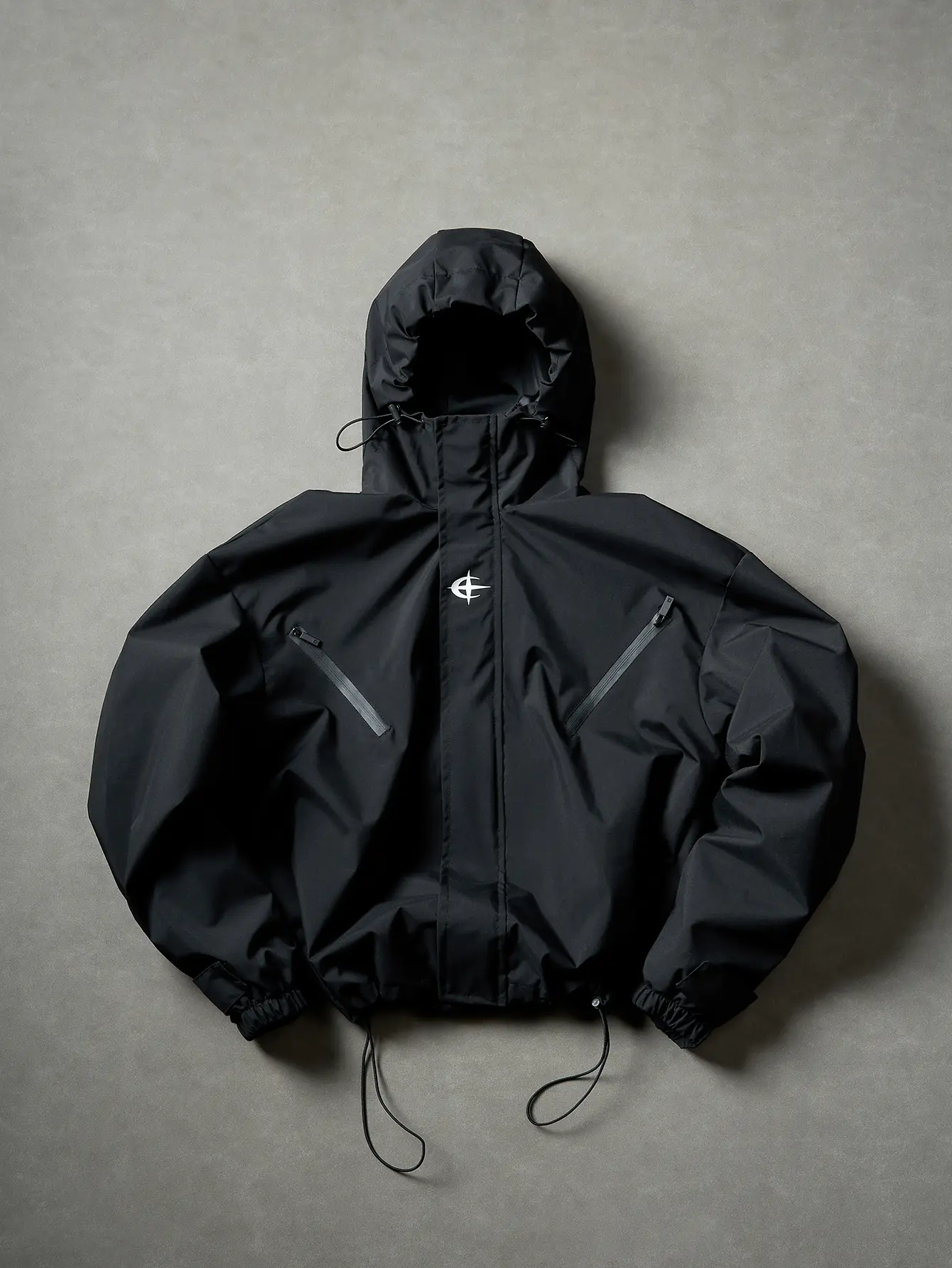 Unisex cropped hooded anorak — water-repellent, wind-resistant, breathable; drawstring hood and hem; zip pockets; embroidered logo; flattering fit; American high-street tech style