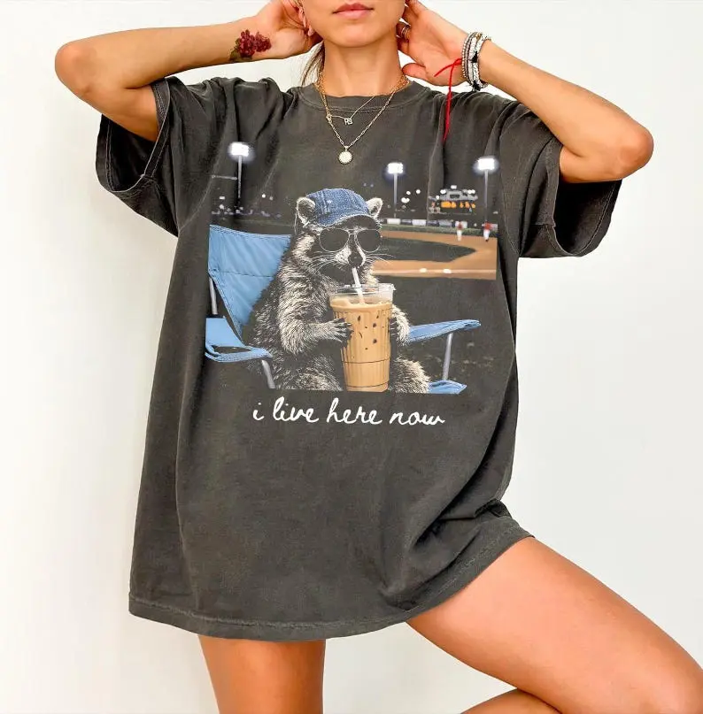 (Sale Off Up To 50%) Comfort Colors Raccoon I live Here Now Shirt, Raccoon Drinking Iced Coffee Shirt, Ballfield Dark Shirt, Baseball field, Baseball Mama Tee. Full Color, For Men, For Women, Casual, Classic Fashion, Tee Print