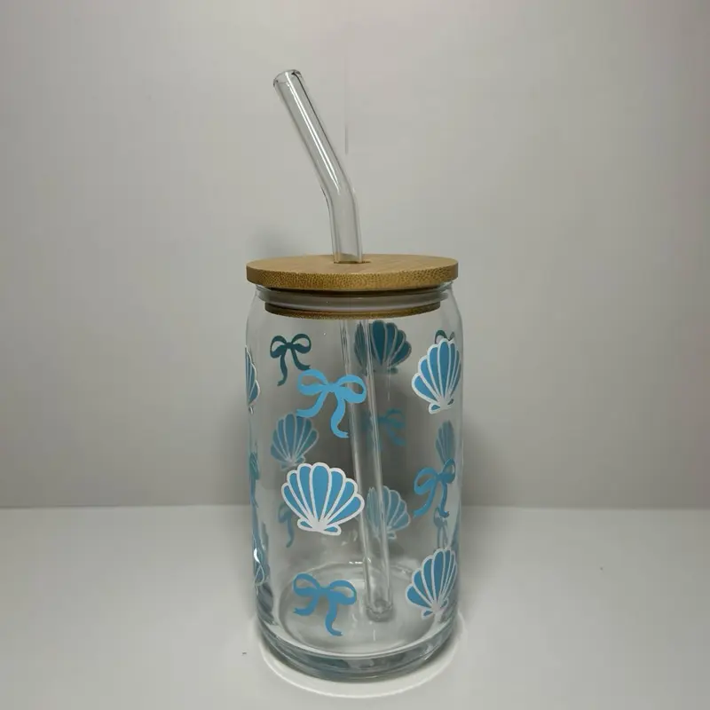 Eco friendly glass cup with elegant blue bows and sea shells. Includes bamboo lid and glass straw.
