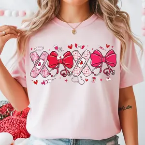 Valentine Nurse T-Shirt for Women, Coquette Pink Nurse Shirt with Bow & Hearts, Cupid’s Favorite Nurse Graphic Tee, Cute Medical Valentine Love Design, Casual Valentine’s Day Gift for Nurses & Healthcare Workers