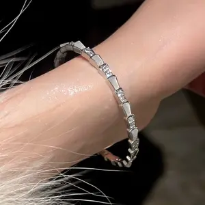 Titanium steel open bracelet with mother-of-pearl spirit snake & snake bone design. Inlaid with sparkling zircon, fade-resistant, ins-style light luxury silver accessory.