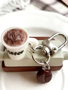 A fun keychain pendant in the shape of a coffee cup and coffee beans, featuring a playful and cute style. It is suitable for coffee lovers to hang on their bags or keys in daily life, adding personality and a sense of life to leisure scenes such as commut