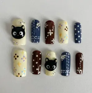 Cute Nails With Black Cat Charms, Polka Dots, Florals, Stars And Playful Patterns In Cream, Navy And Brown Shades Creating A Fun Whimsical Style