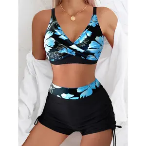 Romantic vacation-style blue floral print two-piece swimsuit , featuring high-waisted shorts and a cross drawstring