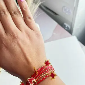 Elegant Red Beaded Bracelet with Gold Accents and Star Charms for Women's Fashion