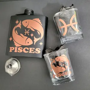 Pisces Zodiac Flask Set – Rose Gold Edition Product Highlights  - Includes: 1 Pisces flask (6 oz), 2 square shot glasses (2 oz each), 1 mini funnel   - Rose gold metallic detailing with Pisces glyph, fish symbol, and star accents   - Matte black stainless
