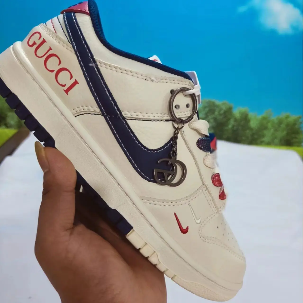 Off-white navy red accented retro low-top sneakers featuring scuff-proof dual-tone navy white layered vintage gum rubber outsoles, tear-resistant sweat-wicking soft perforated smooth leather construction, toe embedded multi-hole ventilation cutouts