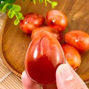 A red agate crystal egg with a random style, perfect for craft enthusiasts. It is an ideal choice for decorating tables during daily festivals and parties, a thoughtful gift for friends, and a Father's Day gift