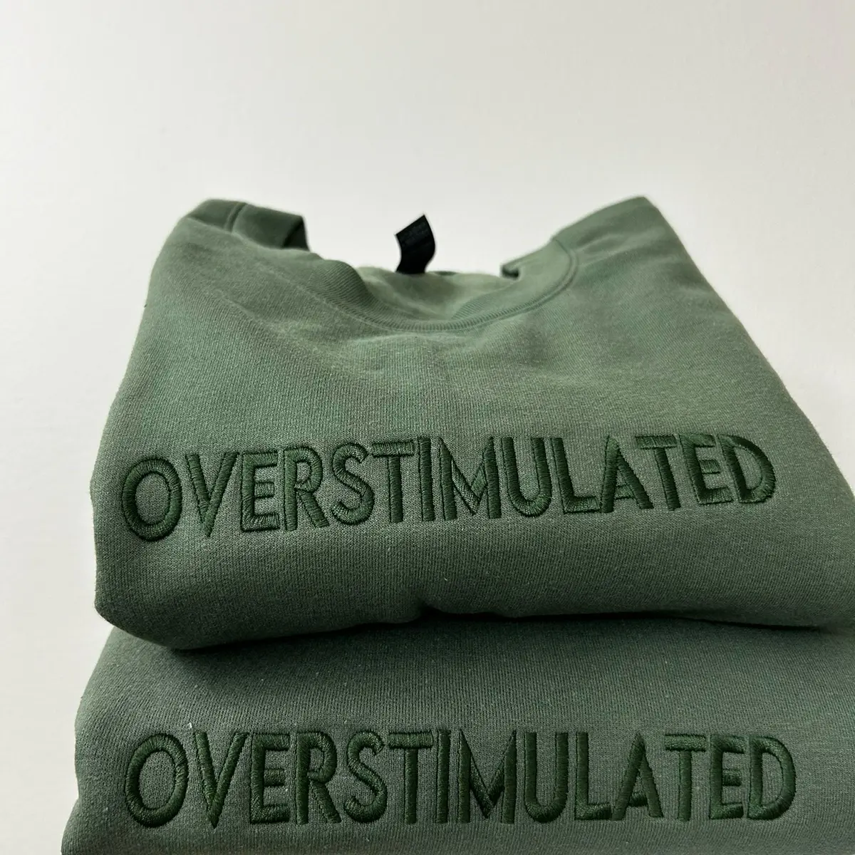 Embroidered “OVERSTIMULATED” trendy and minimalist monochromatic crewneck neutral