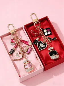 An elegant women's metal keychain with fashionable charms, featuring shapes such as a luxury perfume bottle, lipstick, eyeshadow, high heels, and teardrop pendants, perfect as a gift for family, friends, and loved ones; ideal for various holiday gifts.