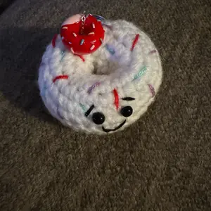 Crochet Donut Keychain - Soft White Design with Red Accents, Features Black Eyes & Smiling Face, Ideal for Gifts and Decor