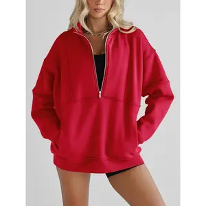 Oversized women’s fleece half-zip sweatshirt with long sleeves, stand collar, thumbholes, pockets, and a pullover design