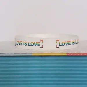 LGBTQIA+ PRIDE Silicone Wristband showing "LOVE IS LOVE" all around the band. Rainbow letters over a white band. Our original and discontinued line, adopt yours today before it's sold out. = )