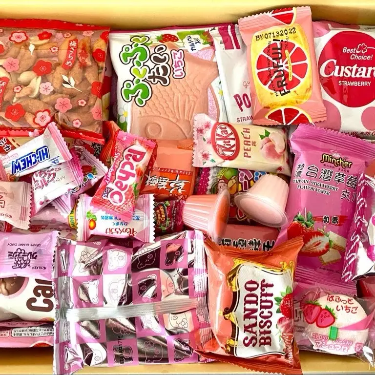 Pink Asian Snack Box with Ramen Drinks Includes Various Candy and Snacks Featuring Strawberry Flavors Sweet Dessert Macarons