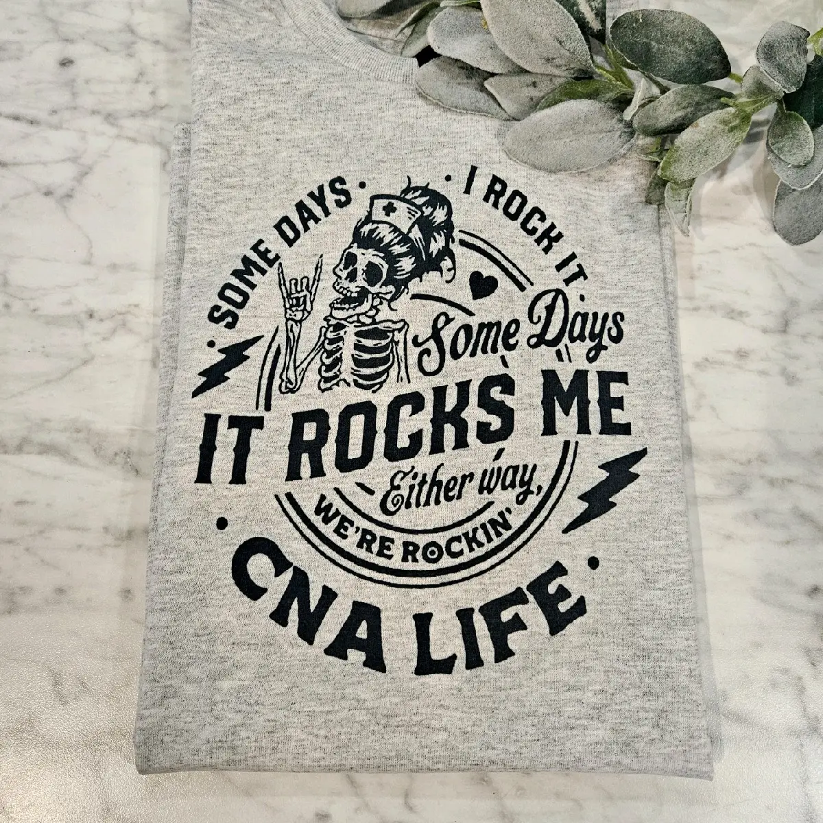 CNA shirt certified medical assistant it rocks me humor messy bun skull popular trendy nurse Unisex Top