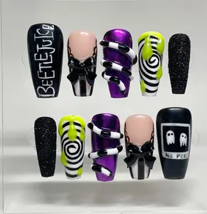 Spooky Beetlejuice-inspired nails with black, white, neon green, and purple swirls, 3D bows, ghost art, and glitter accents for a fun Halloween statement look.