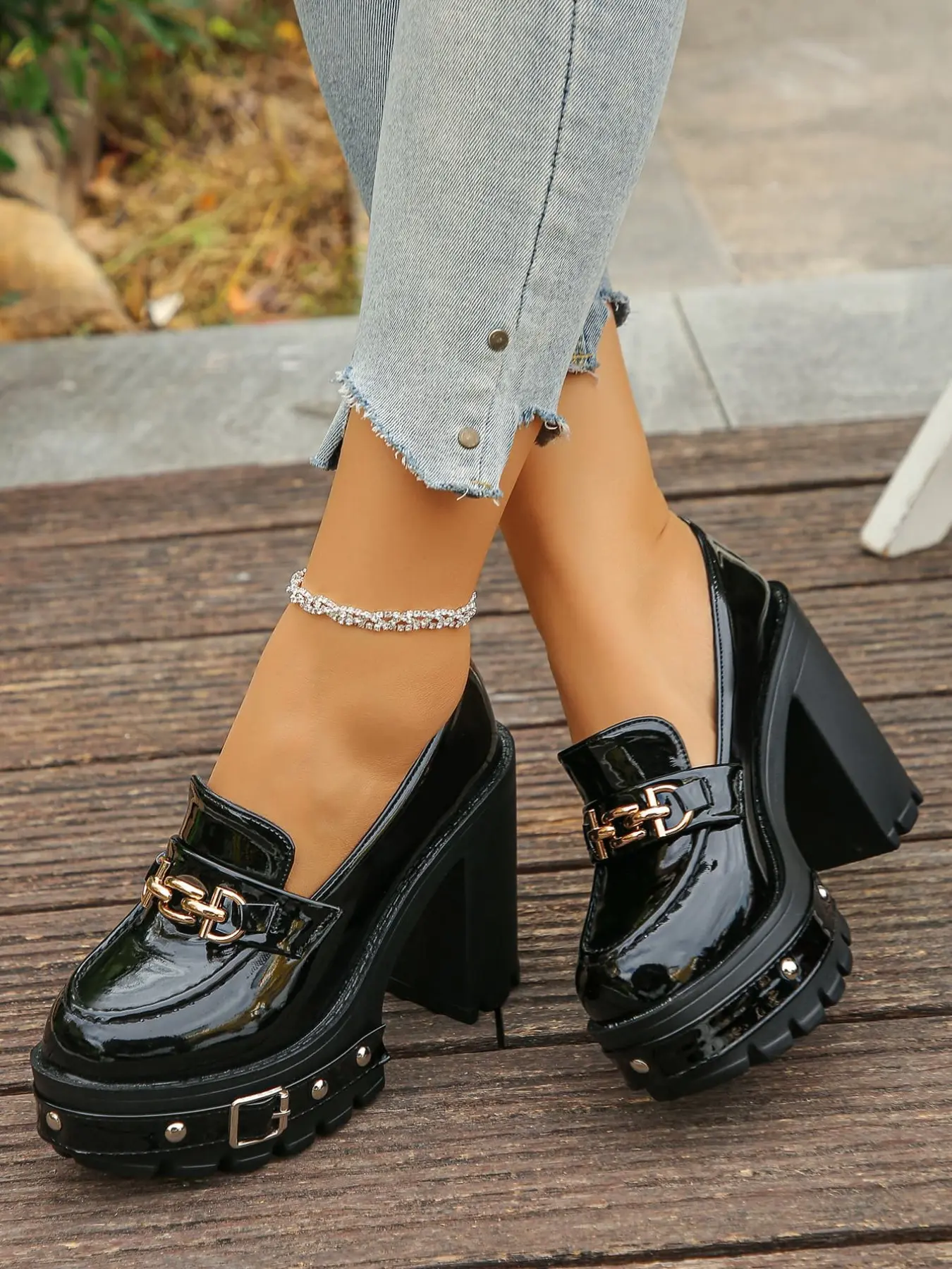 A pair of Women's Platform Block Heel Loafers, Patent Leather Upper, Rubber, Chunky Studded Lug Sole, Metal Chain Accent, Gothic Inspired, Platform Shoes, High Heel Loafers for Parties, Street Style, Bold Footwear, Slip-On Design, Elegant Party Shoes