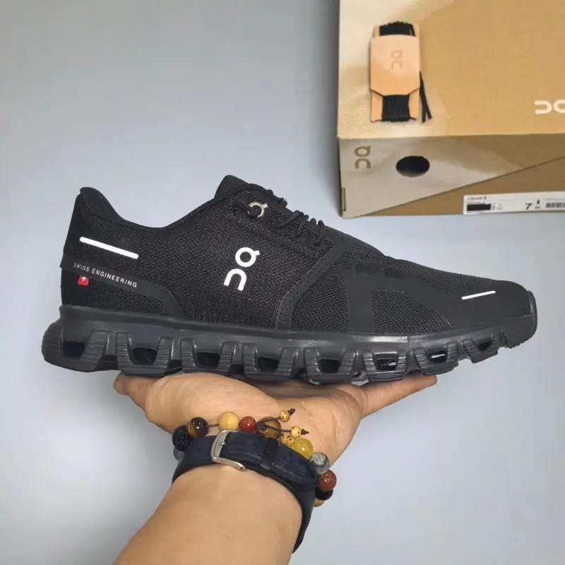 Black reflective white trimmed low-top running sneakers featuring bendable hollow rubber midsole, tear-resistant flexible knit mesh construction, wide porous ventilation sections, rugged anti-slip tread layout
