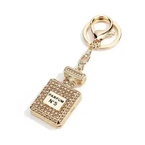Perfume Bottle Champagne Gold Bag Charm with Rhinestone Accents and Elegant Design