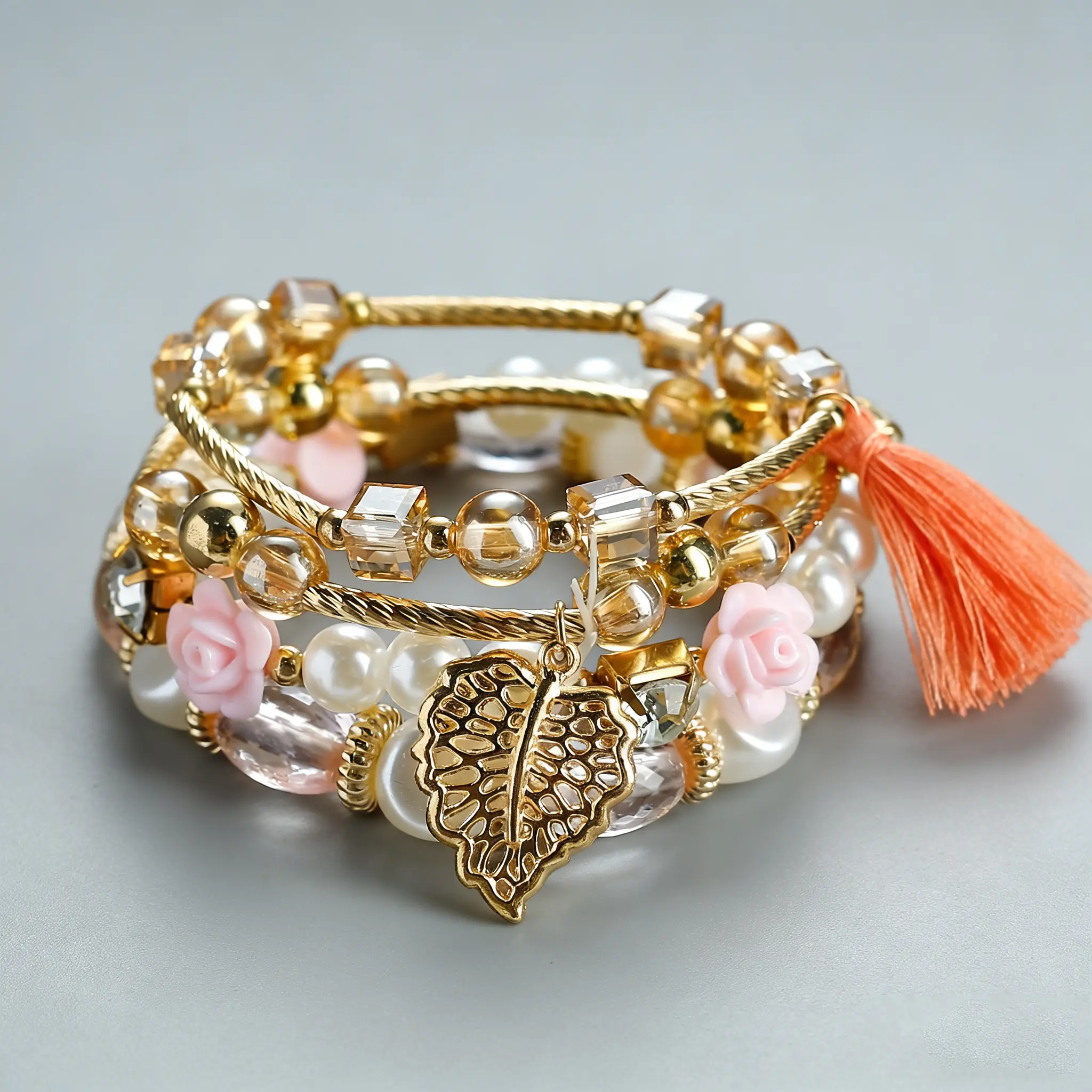 A set of 4 Bohemian-style bracelets, featuring elegant designs with rhinestone embellishments, leaf and tassel pendants, and multi-layered beaded strands.  Handcrafted and fashionable, perfect for everyday wear and as a gift for women.