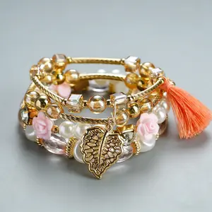 A set of 4 Bohemian-style bracelets, featuring elegant designs with rhinestone embellishments, leaf and tassel pendants, and multi-layered beaded strands.  Handcrafted and fashionable, perfect for everyday wear and as a gift for women.