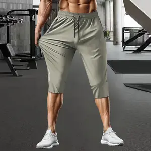 Men's casual stretchable ice silk fabric breathable waist drawstring, zipper pocket fashion sports capri pants with reflective print. Basic comfortable quick-drying breathable outdoor running, cycling, training and sports capri pants.