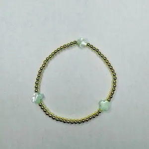 The Radiance bracelet - 6.5” stretchy bracelet Made with: 3mm round gold plated hematite beads with 8mm white color mother of pearl cross beads